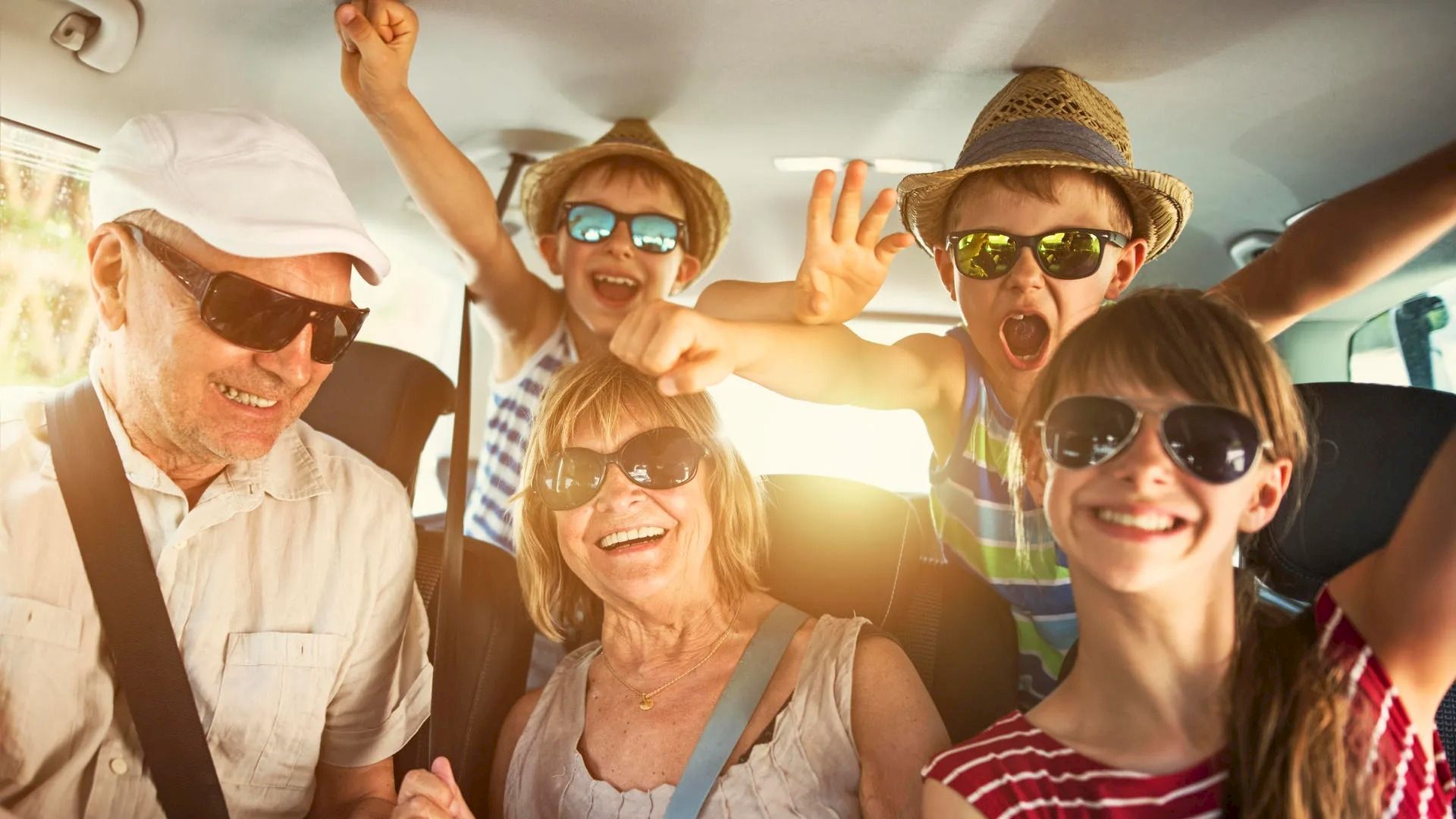 family in a car driving to vacation
